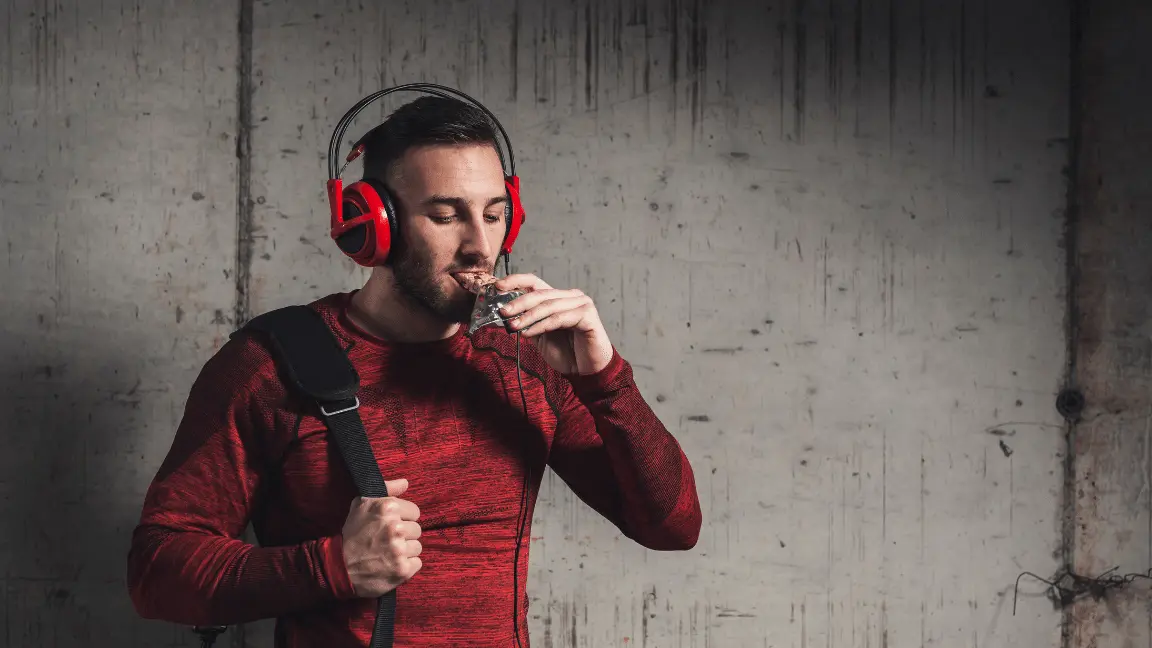 A man is eating protein bars after a workout