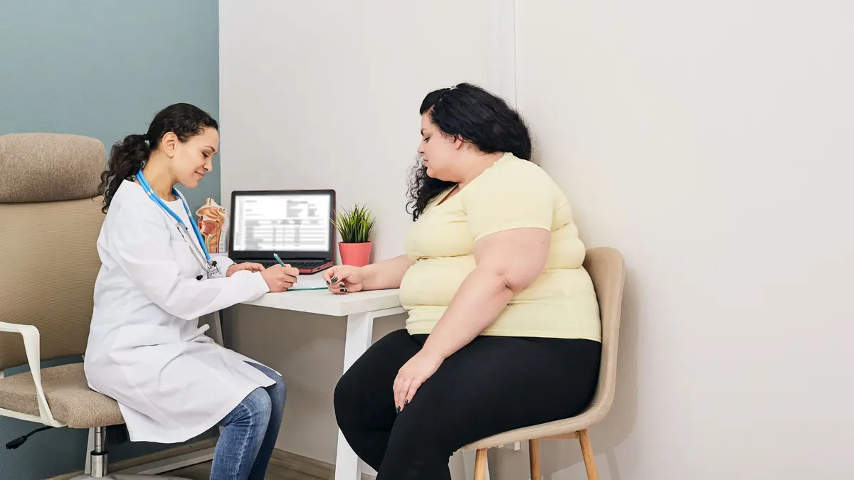 Doctor consulting a sarcopenic obesity patient in a consultation room