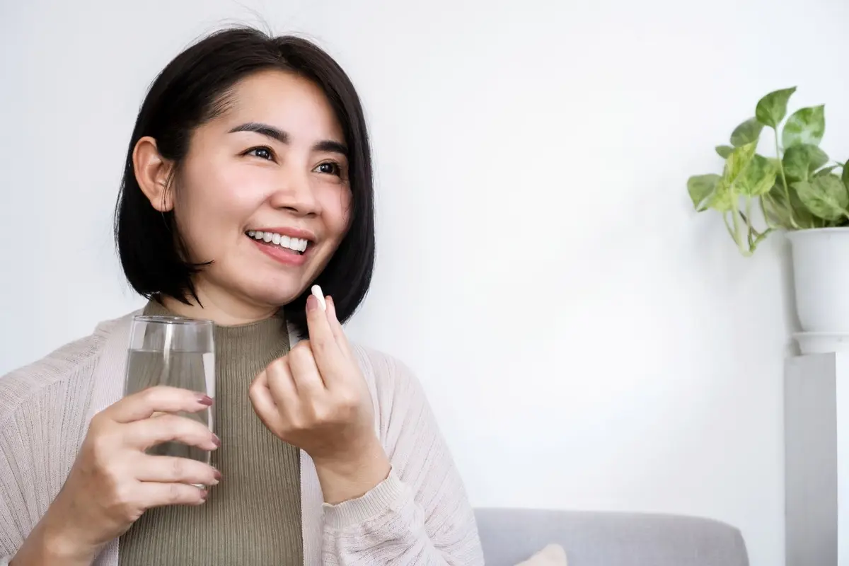 Girl eating a supplement
