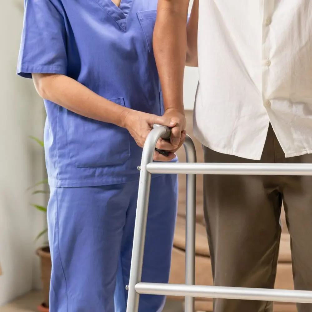 Nurse assisting a sarcopenic patient