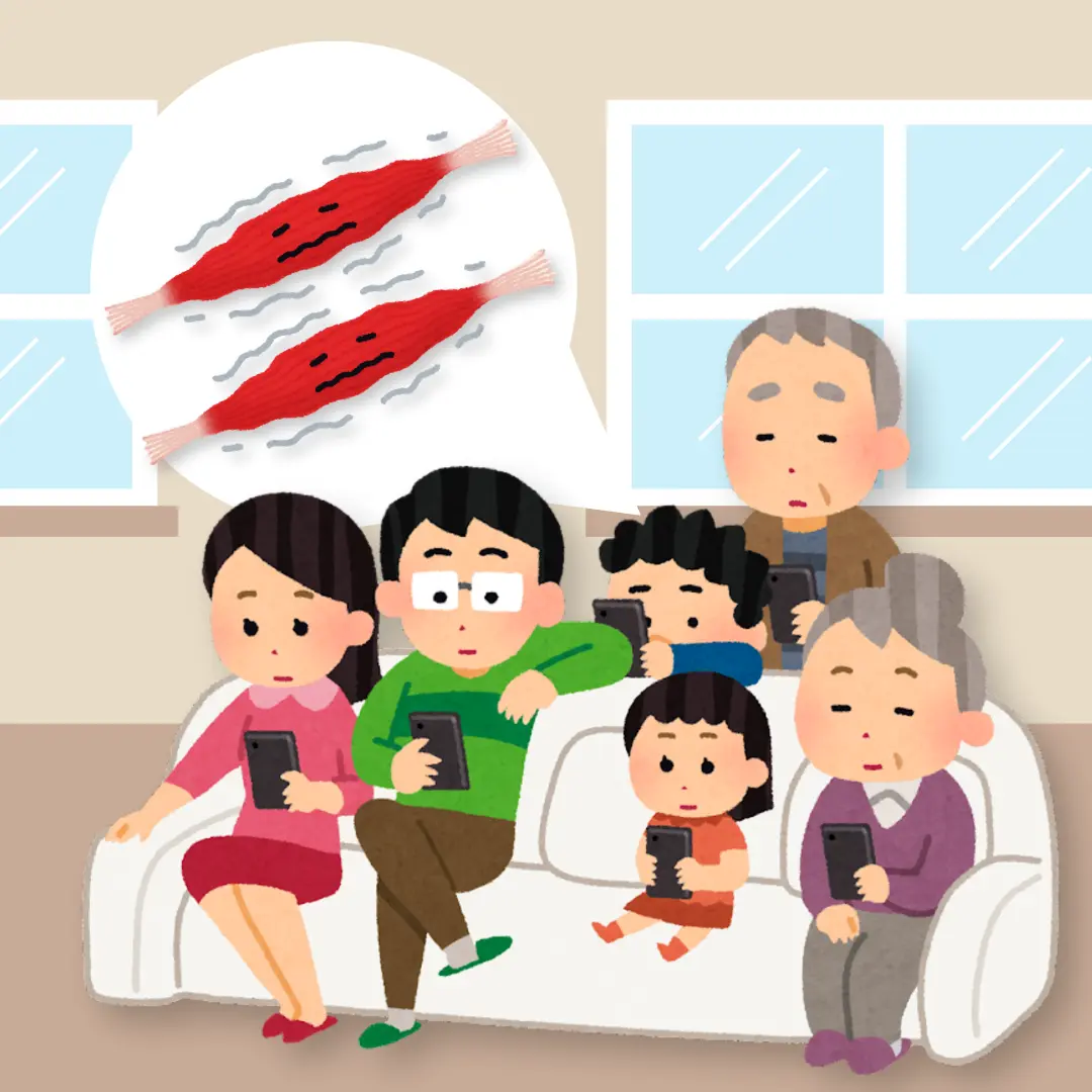 A family sitting on a couch and playing on their phones in their living room
