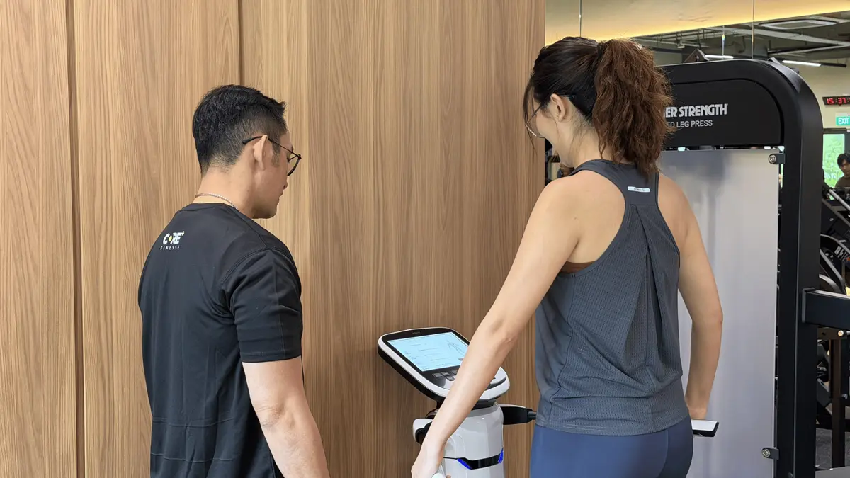 Pilates instructor assisting client on doing an InBody test